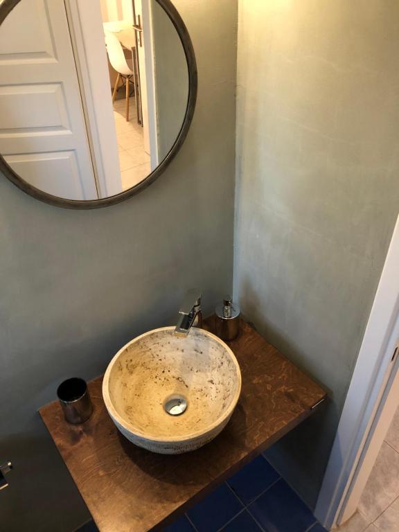 a bathroom with a sink and a mirror on a counter at Aloni Studios and Apartments in Lassi