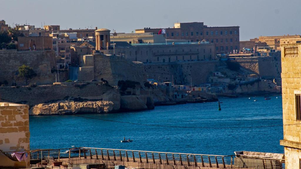 a view of a body of water with a city at Apartment close to Fort Saint Angelo in Vittoriosa