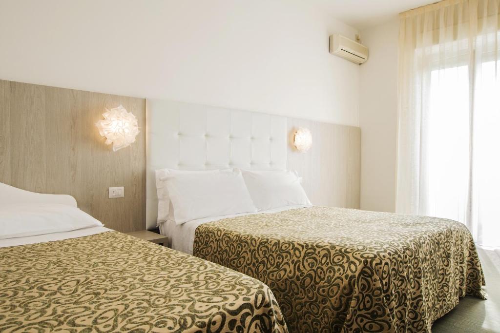 A bed or beds in a room at Hotel Bassetti