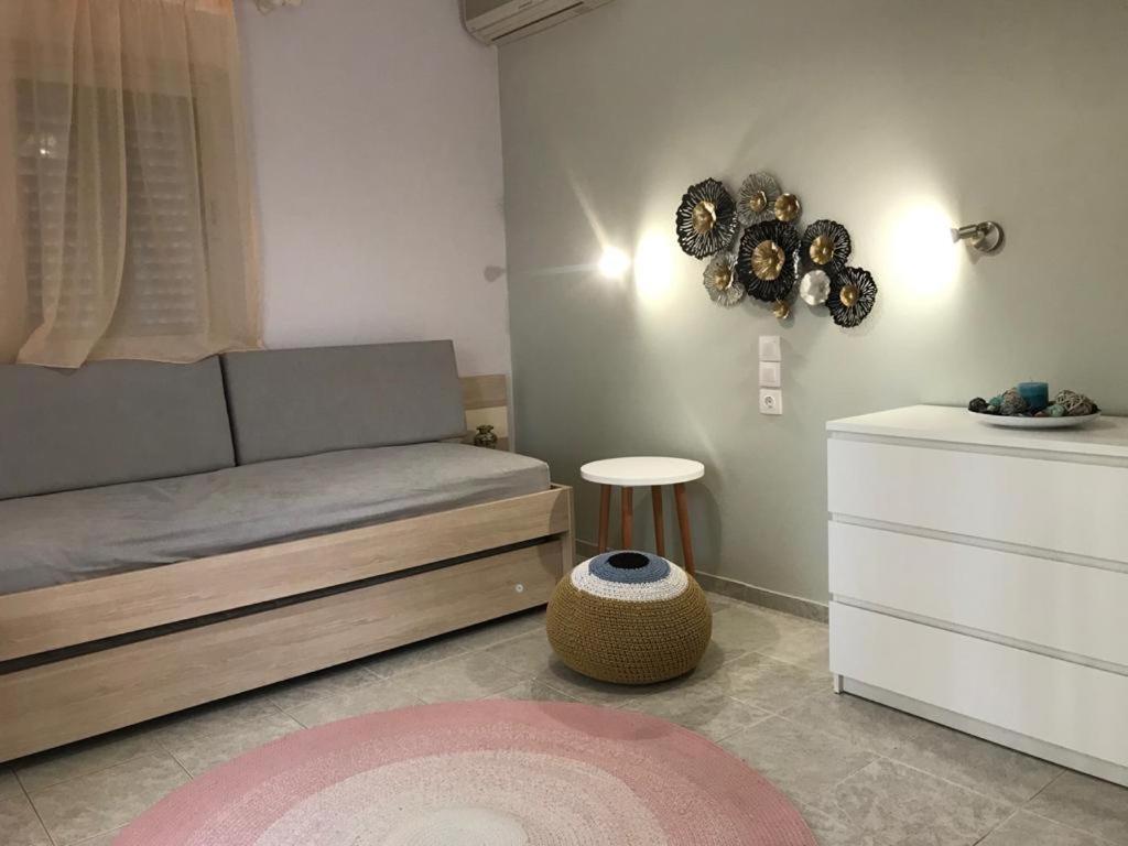a bedroom with a bed and a table and a stool at Aloni Studios and Apartments in Lassi