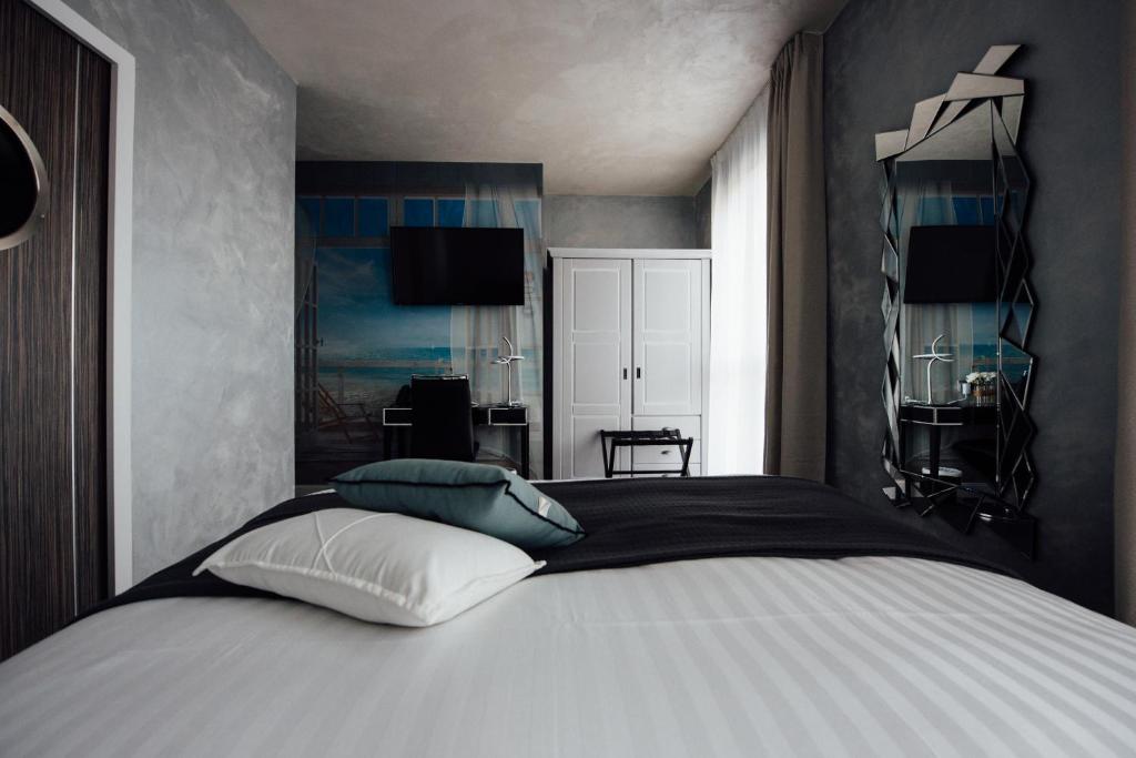 a bedroom with a white bed with blue pillows at Amirauté in La Baule
