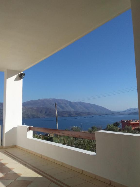 a view of the water from the balcony of a house at Mihal Suites in Sarandë