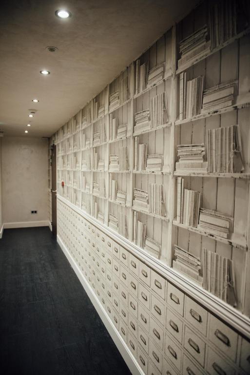 a hallway with shelves of books on the wall at Amirauté in La Baule