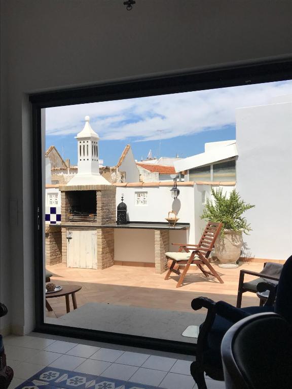 a view of a patio from a window at The Blue House in Olhão