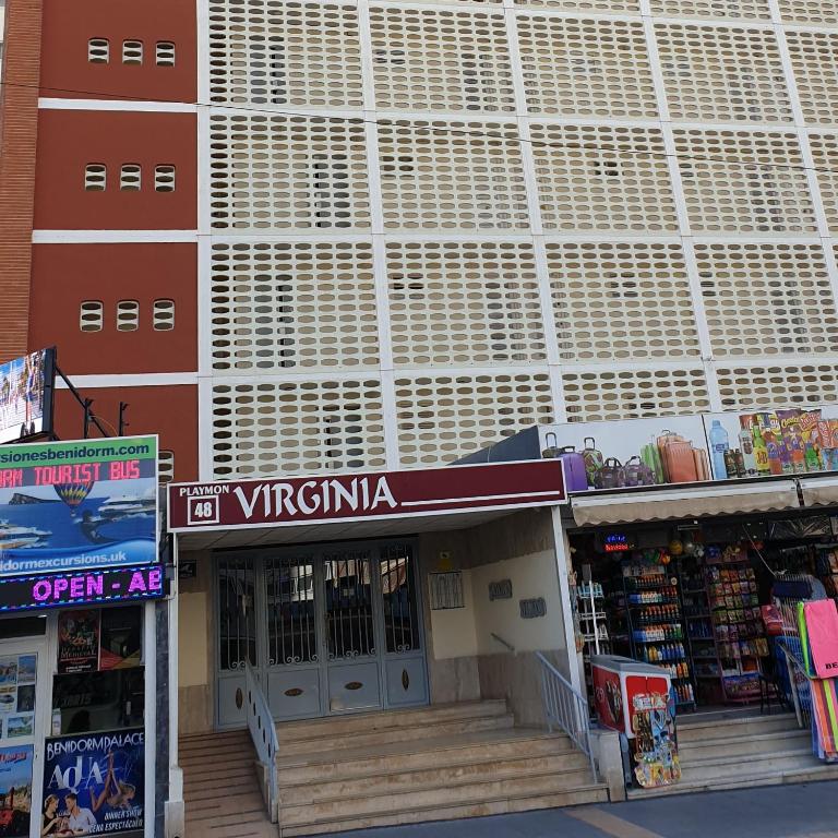 a store with a sign in front of a building at virginia-48 in Benidorm