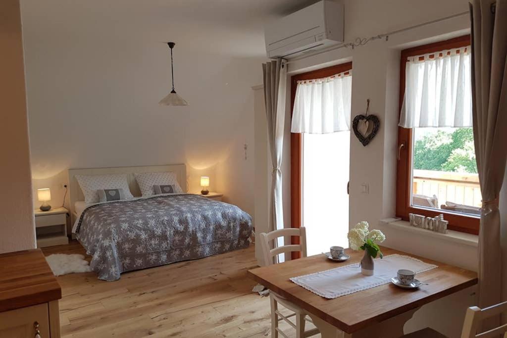 a bedroom with a bed and a desk and a table at Castle View Nest in Bled