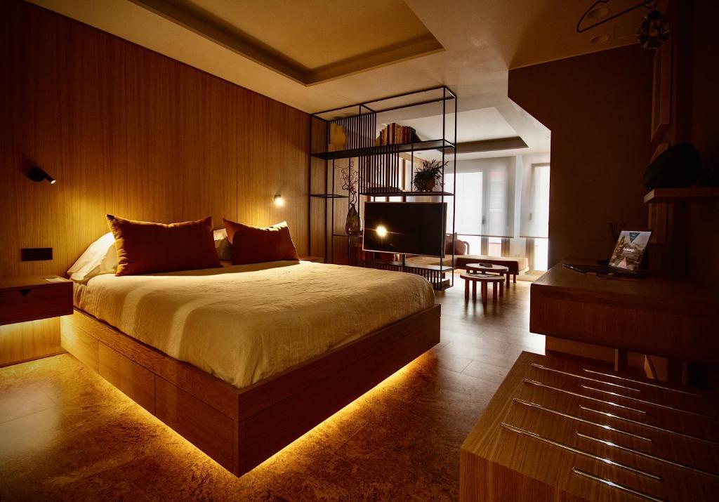 a bedroom with a large bed and a television at the matter Meaningful apartments in Las Palmas de Gran Canaria