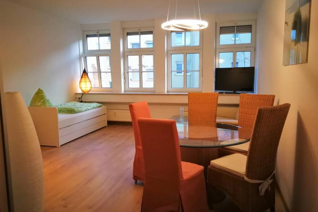 a living room with a table and chairs and a couch at Apt next to Nuremberg central-station, Fair 10min in Nuremberg