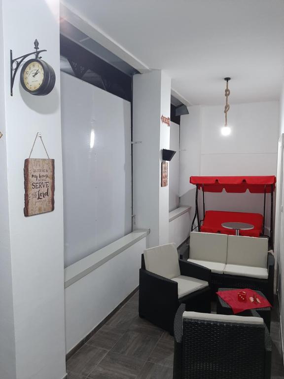 a room with a bed and a table and chairs at Apartmani LolaNola in Vrnjačka Banja