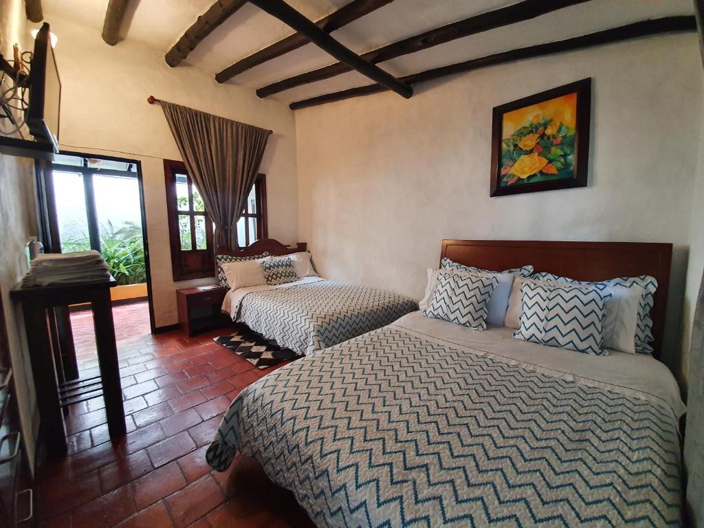 Postel nebo postele na pokoji v ubytování Hotel Quinta de Santa Ana