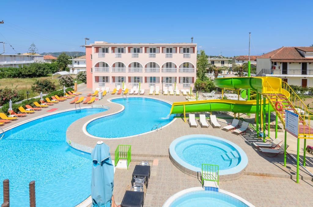 a large pool with a slide and a water park at Aeon Hotel in Laganas