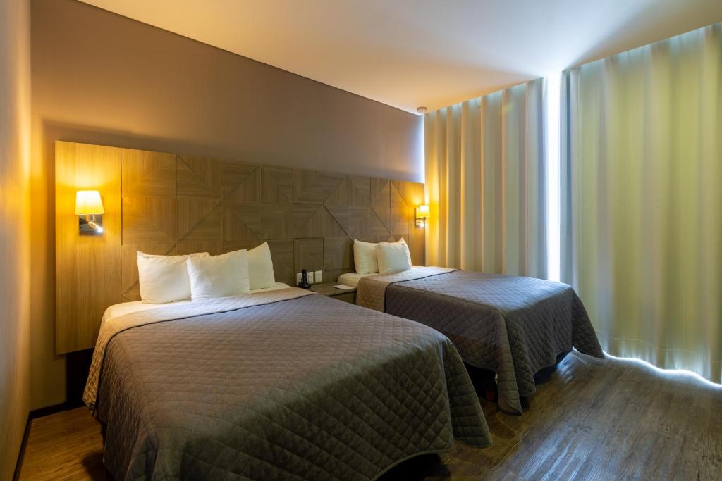 Postel nebo postele na pokoji v ubytování Hotel Glow Point - Mulza