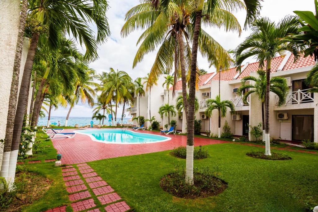 een afbeelding van een resort met een zwembad en palmbomen bij Chrisanns Hidden Cove 2 bedroom in St Mary