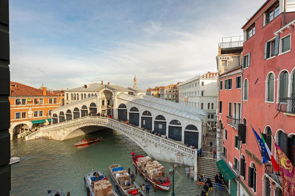 a bridge over a river in a city with buildings at Vip Venice Apartments and Rooms San Marco 5134 e 274 in Venice