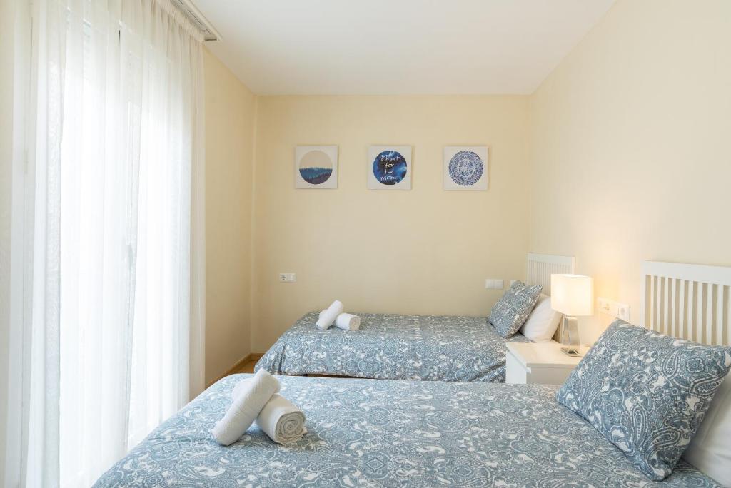 Łóżko lub łóżka w pokoju w obiekcie Alferez II by ELE Apartments