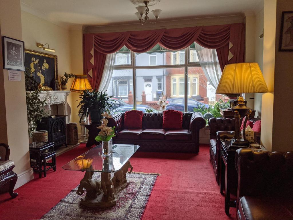 a living room with a couch and a window at The New Guilderoy Hotel in Blackpool