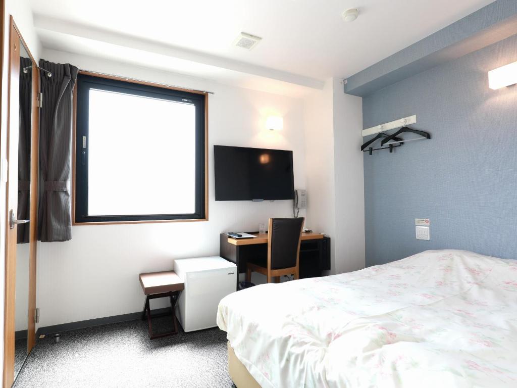 Postel nebo postele na pokoji v ubytování Toyama Town Hotel