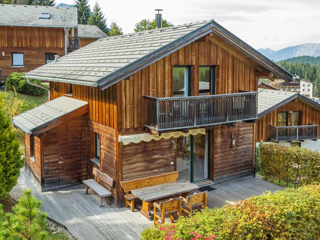 a log cabin with a deck and a table at Chalet in Annaberg-Lungötz with shared Sauna in Annaberg im Lammertal