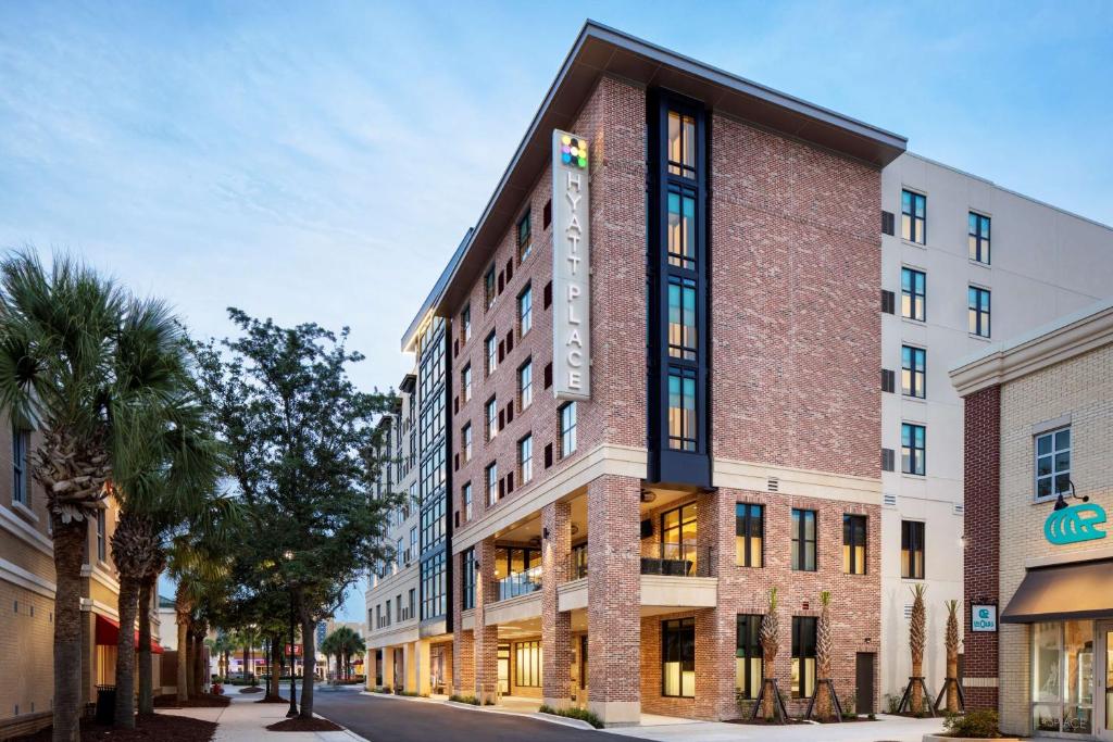 a tall brick building on a city street at Hyatt Place Mount Pleasant Towne Centre in Charleston