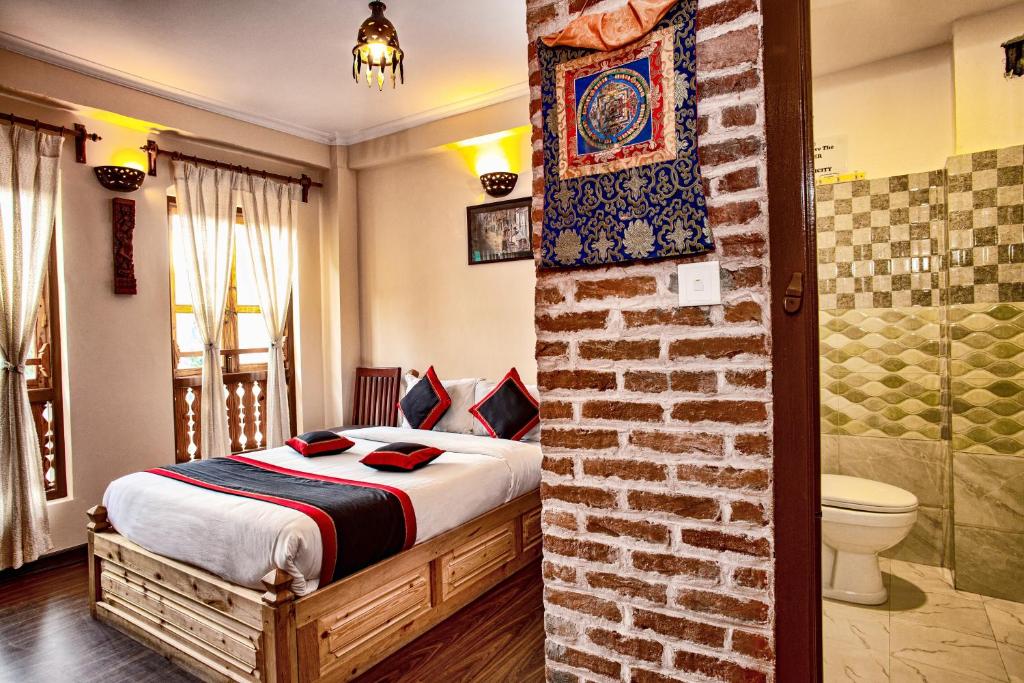 a bedroom with a bed and a bathroom with a shower at Newa Home in Kathmandu