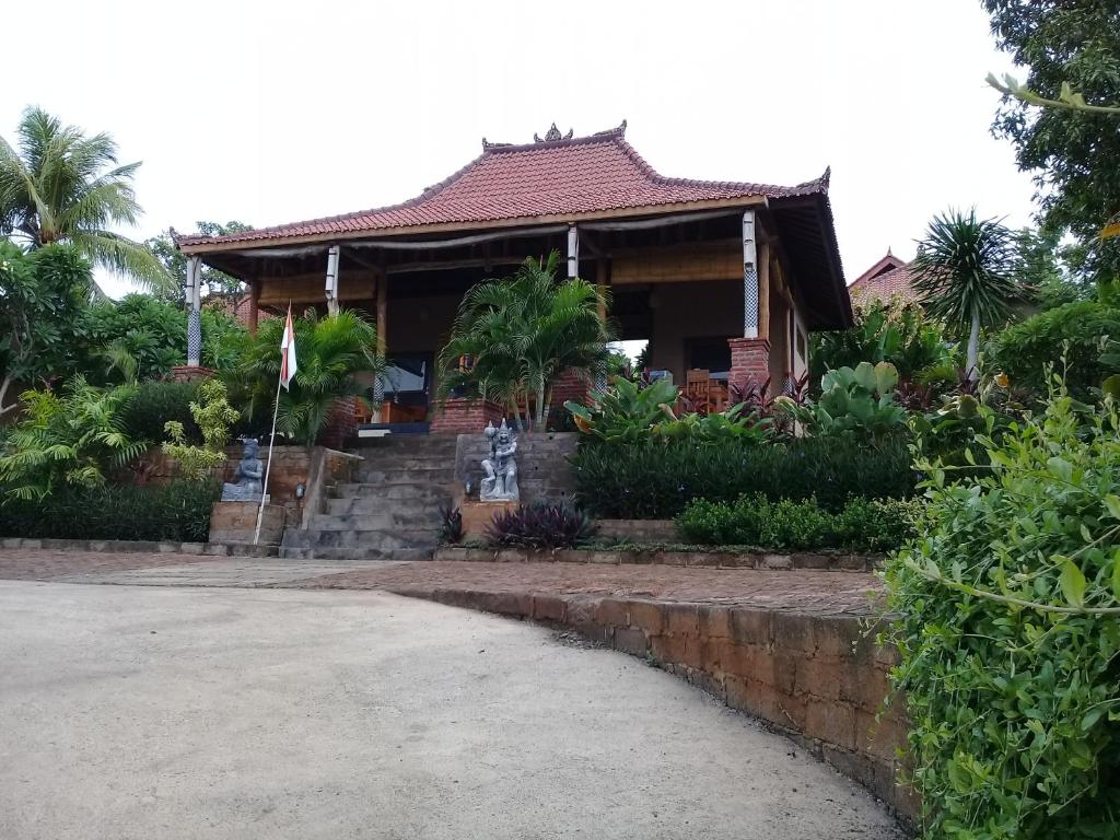 a house with a flag in front of it at Villa Eliska Sari Sumberkima in Pemuteran