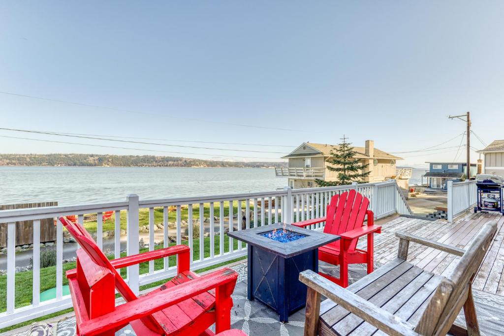 a deck with two chairs and a table and two chairs at Tyee Legacy in Tyee Beach