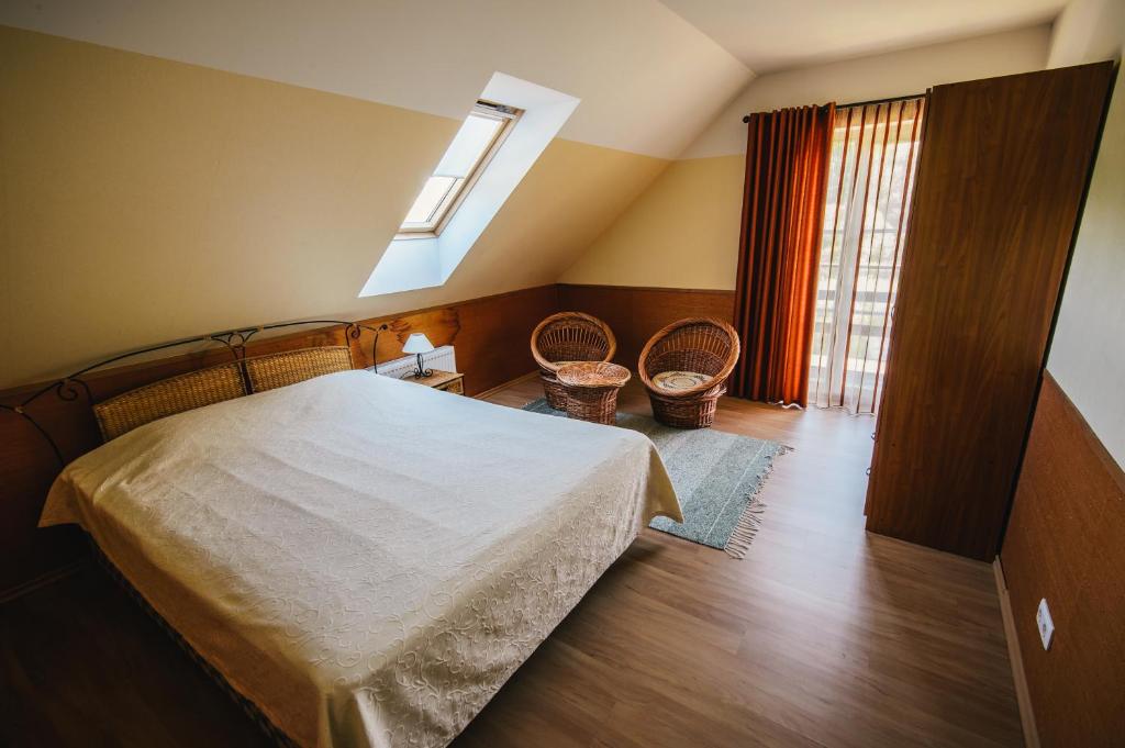a bedroom with a bed and a skylight at Vanaõue in Suure-Jaani