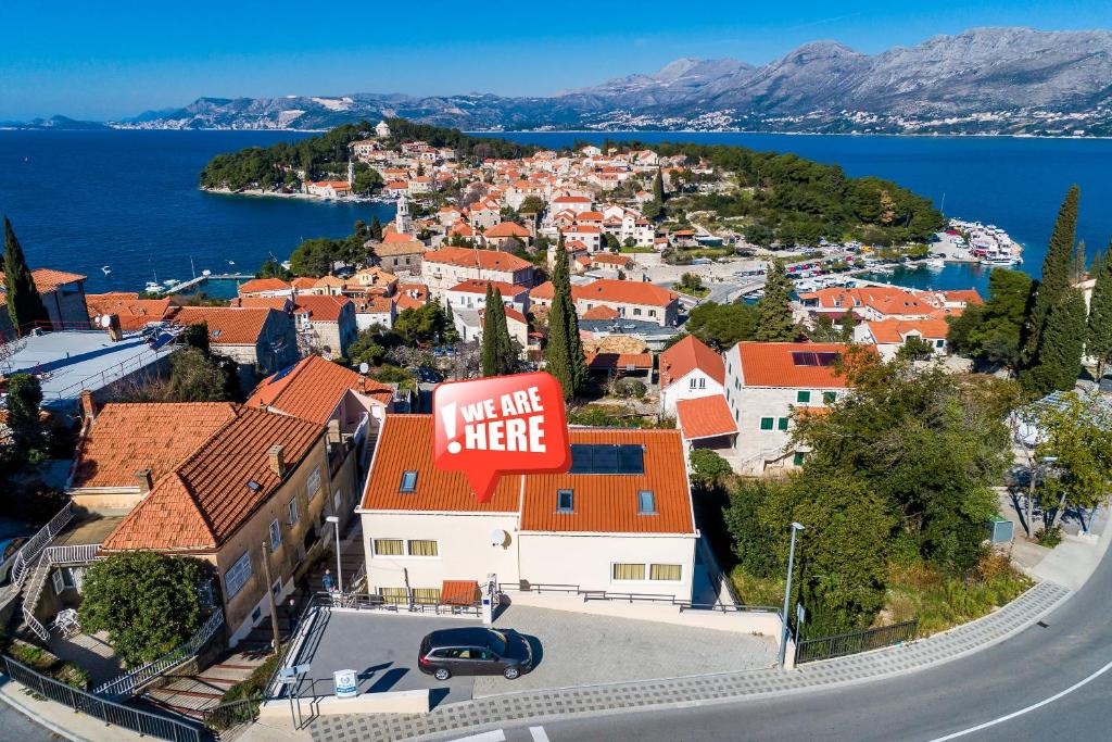 a town on a hill with a sign that reads take a risk here at Apartments Rilovic, City and Sea view apartments in Cavtat