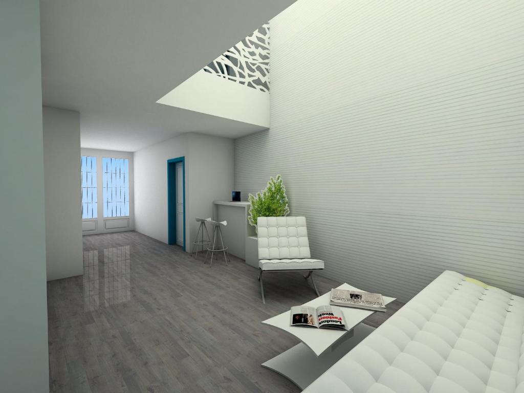 a living room with a bed and a chair at Nerja Casual Rooms in Nerja