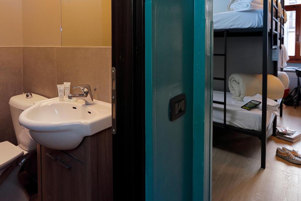 a bathroom with a sink and a bunk bed at Plus Florence in Florence