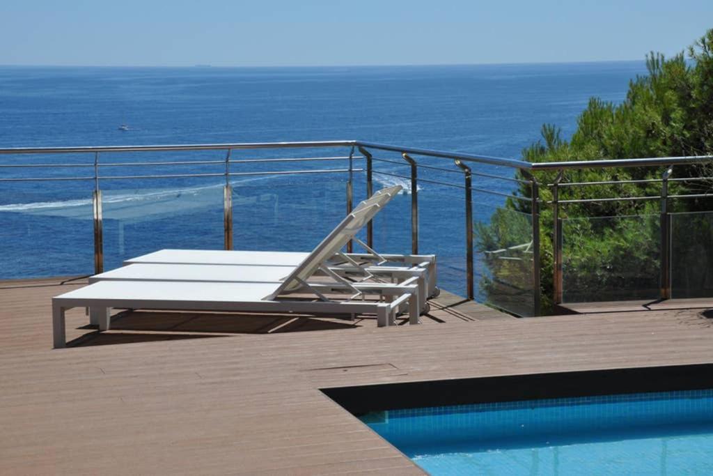 a swimming pool with a lounge chair next to a swimming pool at DUPLEX DE CARA EL MAR 210 m2 in Tamariu