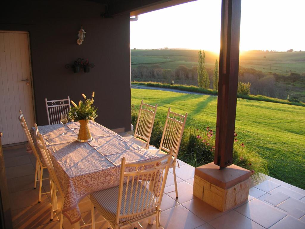 a table and chairs on a porch with a view at Giant's View Village in Nottingham Road