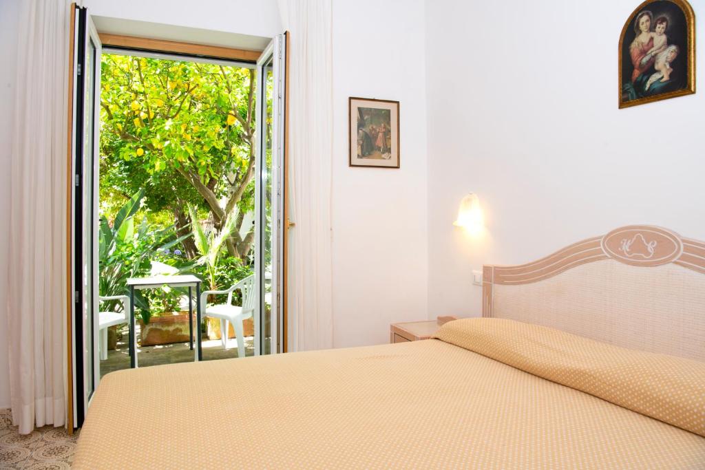 Postel nebo postele na pokoji v ubytování Hotel Candia