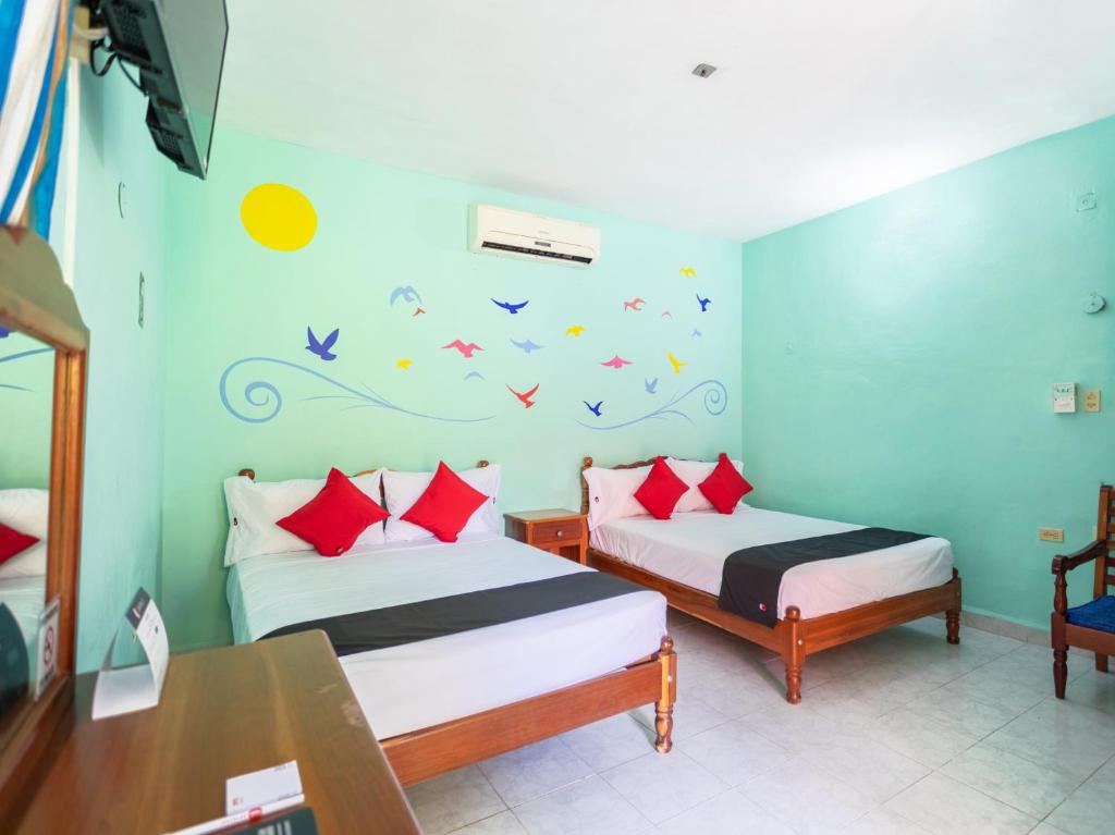 Postel nebo postele na pokoji v ubytování Hotel Hacienda Bacalar