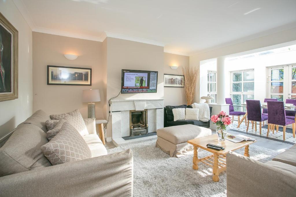 a living room with a couch and a fireplace at Georgian Square Apartments in Dublin