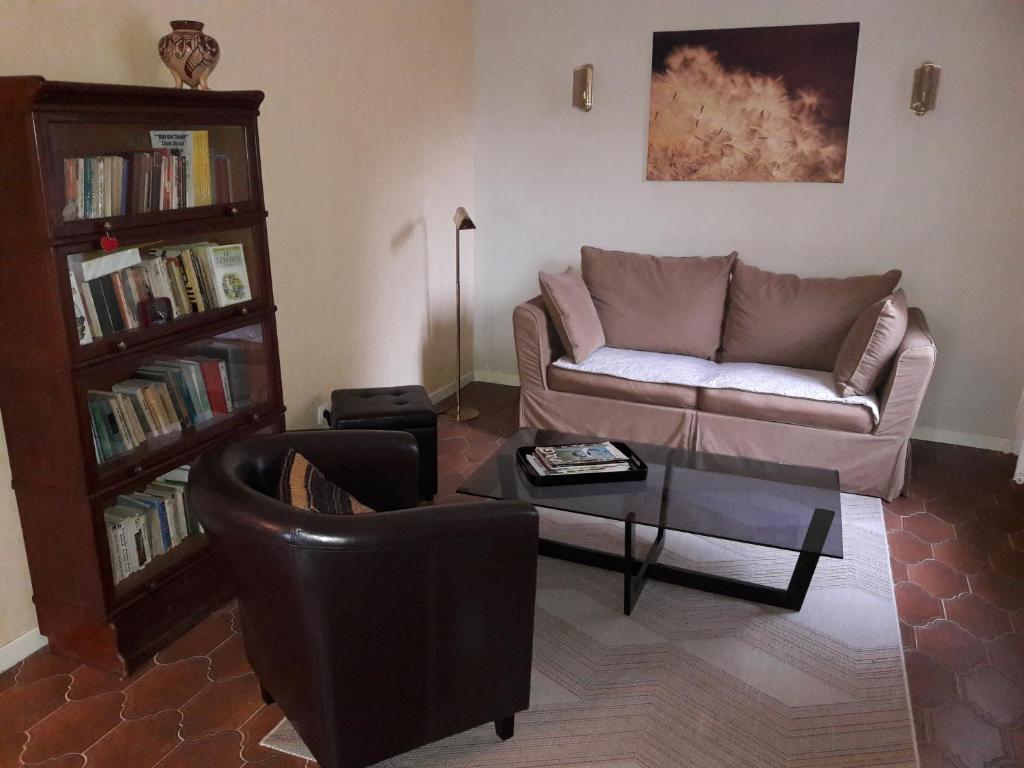a living room with a couch and a coffee table at VILLA LA LURETTE, appartement et studio in Saint-Étienne-les-Orgues