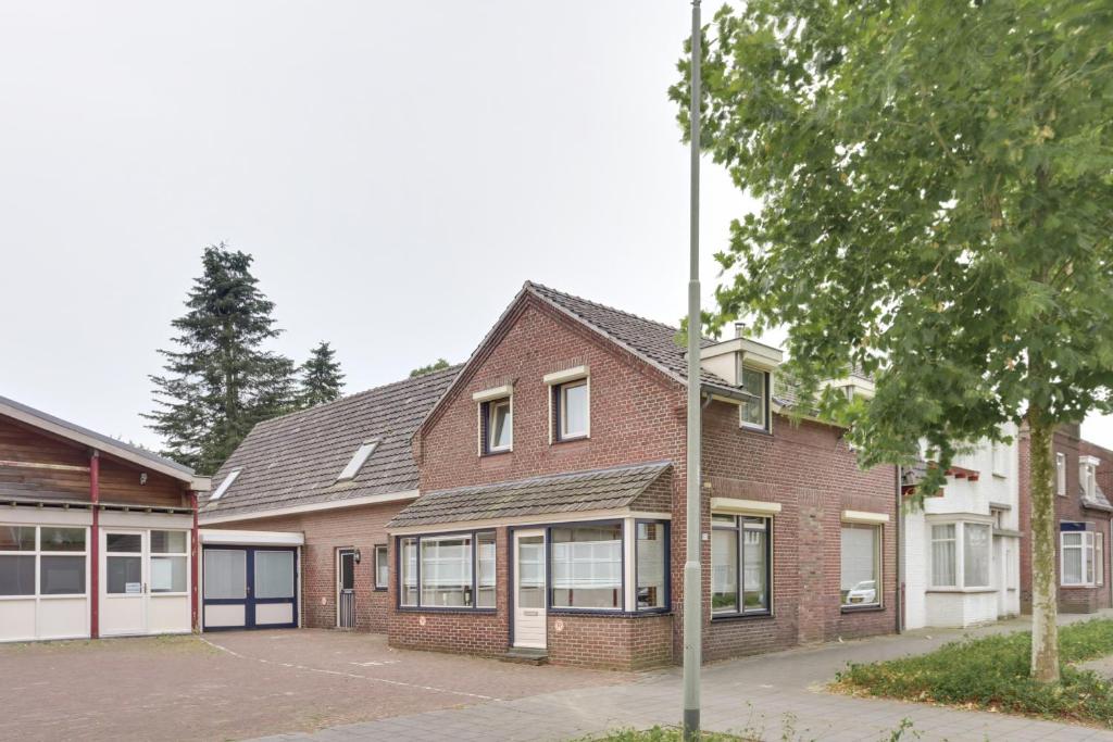 un edificio de ladrillo con un poste delante de él en B&BBolwerk, en Venray