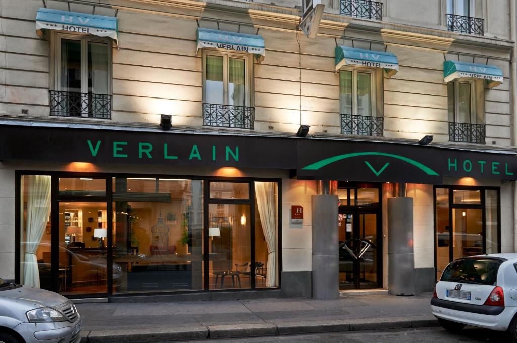 a facade of a hotel with a sign for a hotel at Verlain in Paris