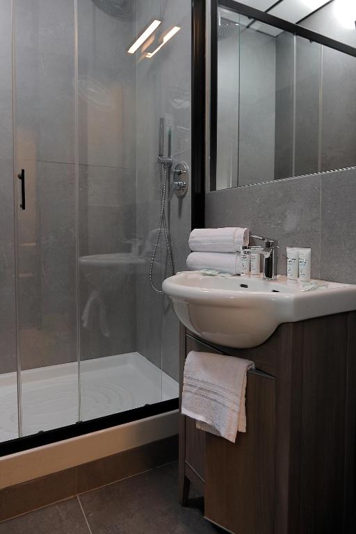 a bathroom with a sink and a shower at Plus Florence in Florence
