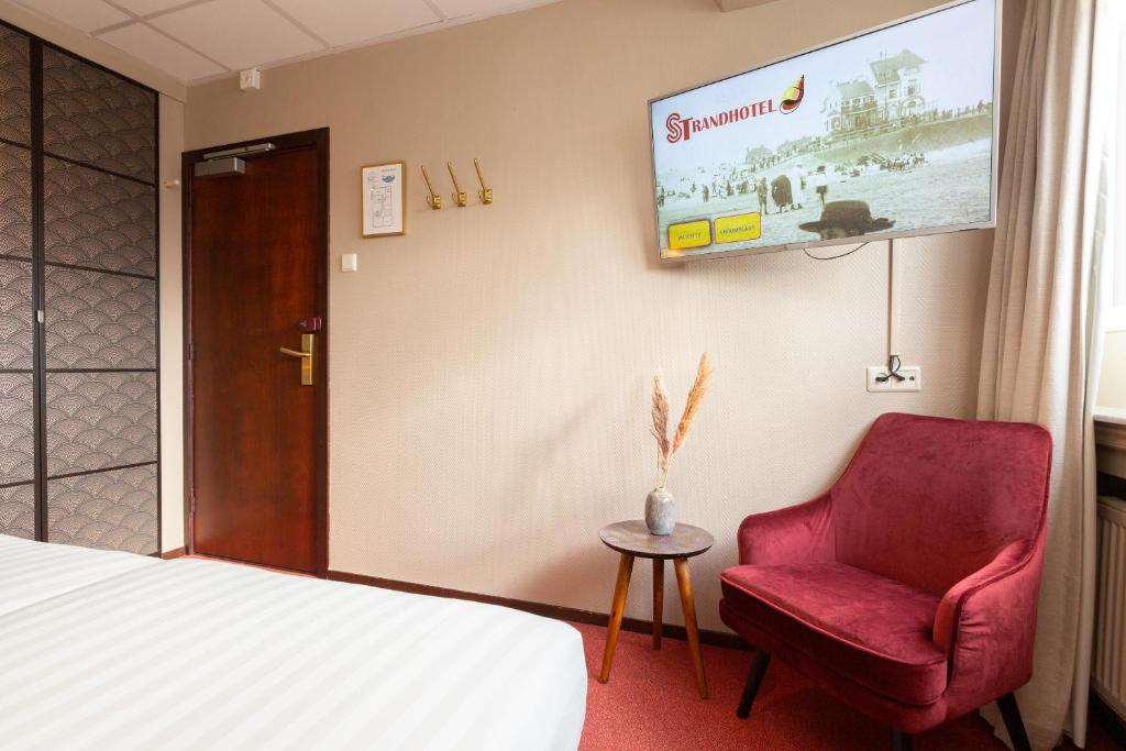 Postel nebo postele na pokoji v ubytování Strandhotel Scheveningen