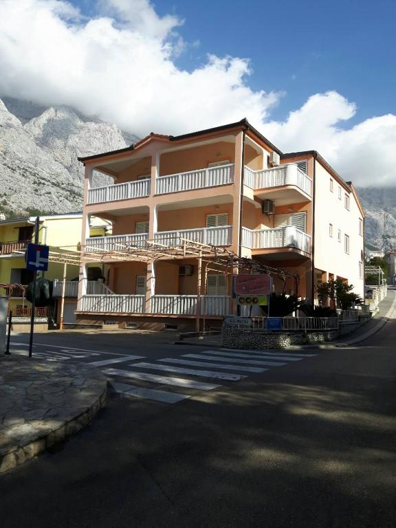 a large building on the side of a street at House Vida Goraleks in Baška Voda