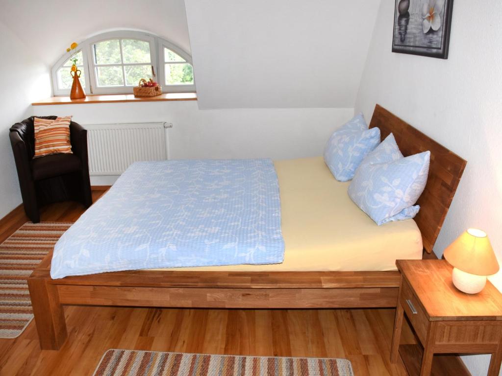 a bedroom with a bed and a table and a window at Landhaus im Grünen in Nehringen