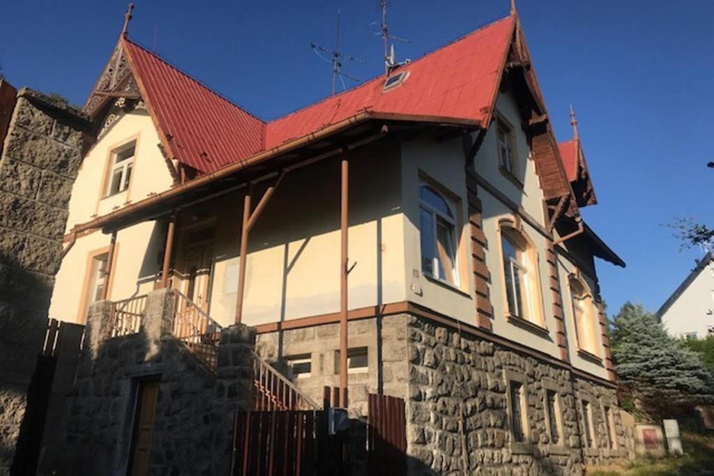 a large white house with a red roof at Vila Polacek in Nejdek