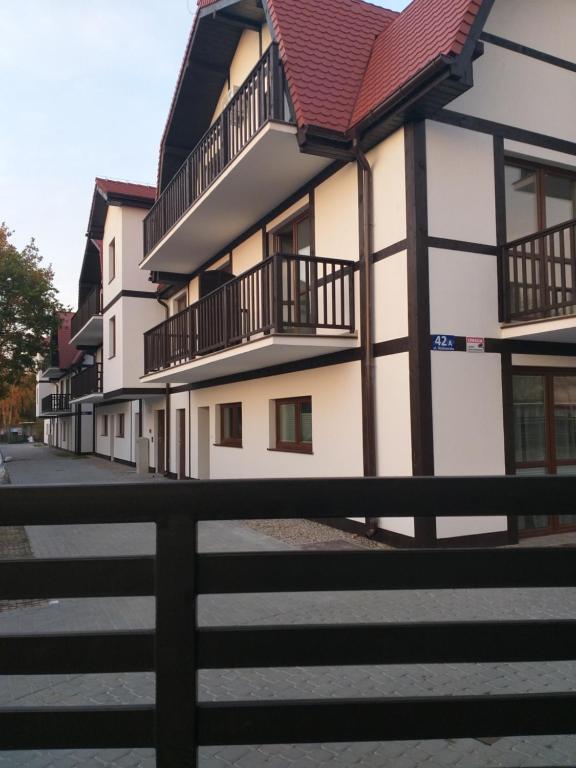 a row of houses with balconies on a street at Rowy Apartament.b5 in Rowy