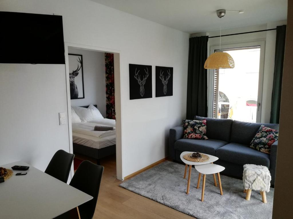 a living room with a couch and a table at Cityapartment am See in Pörtschach am Wörthersee