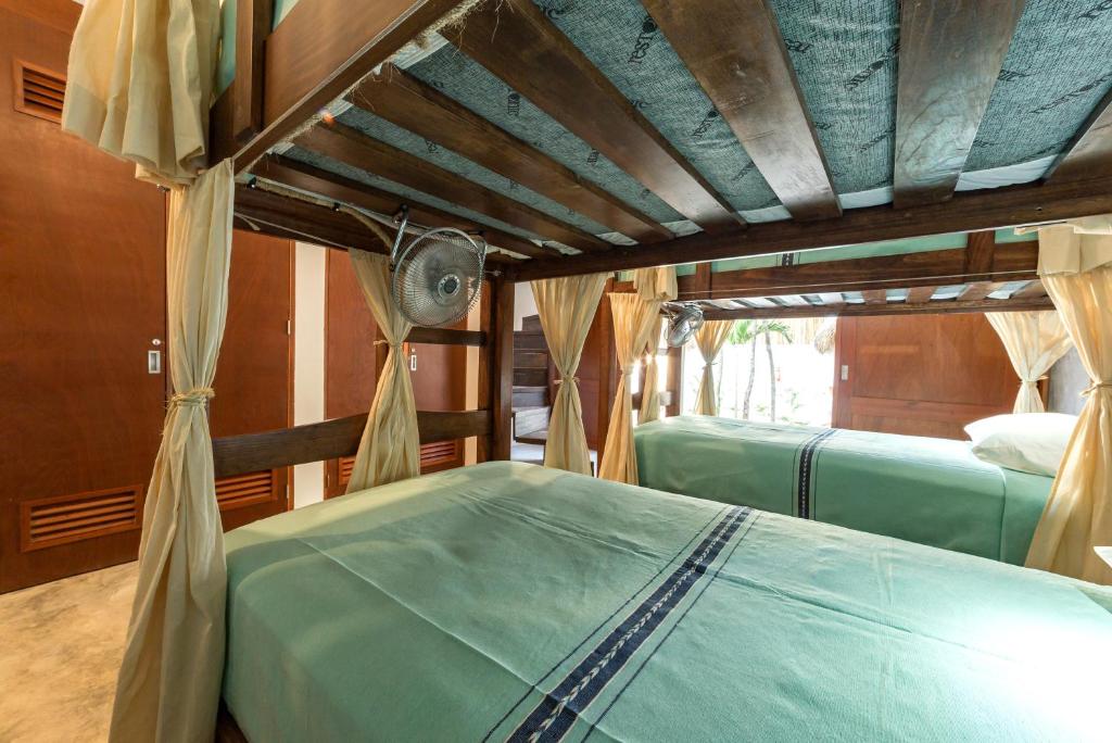 Una cama o camas en una habitación de Mimosa Tulum
