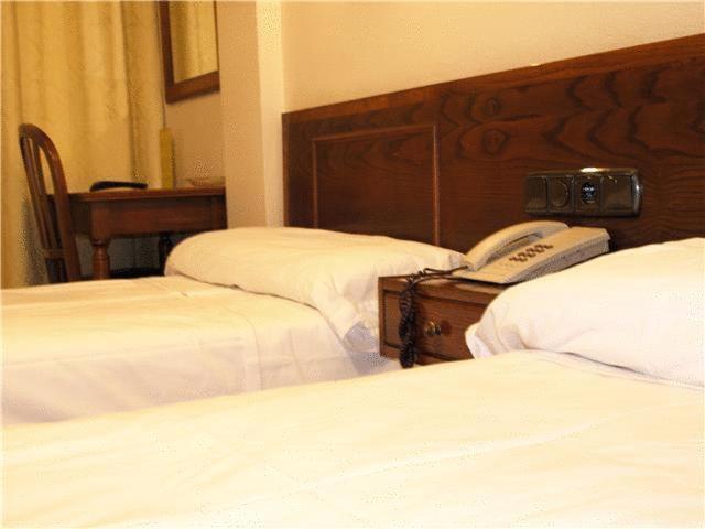 Postel nebo postele na pokoji v ubytování Hotel Ibiltze