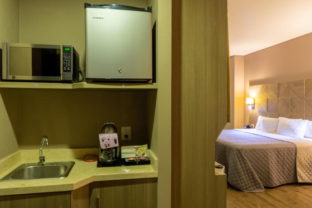 Postel nebo postele na pokoji v ubytování Hotel Glow Point - Mulza