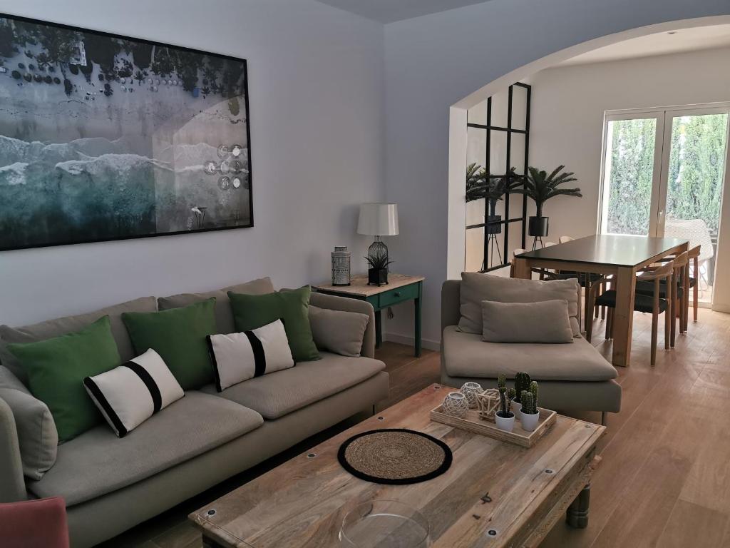 a living room with a couch and a table at Villa Bahía in Port de Pollensa