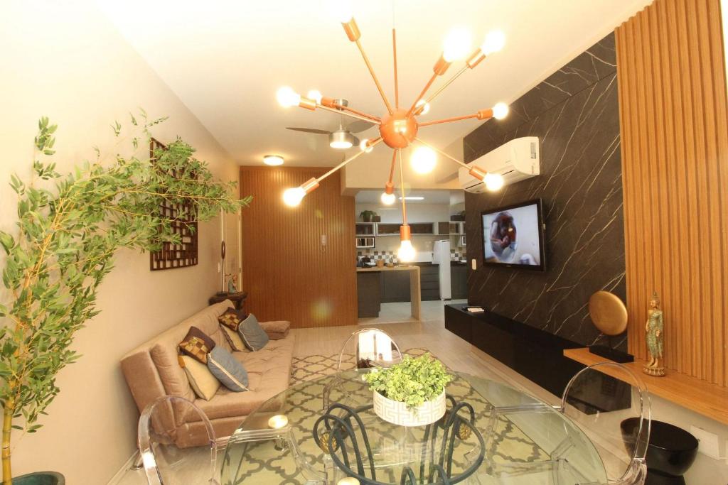 ein Wohnzimmer mit einem Glastisch und einem Sofa in der Unterkunft Residencial Altos da Bela Vista in Gramado